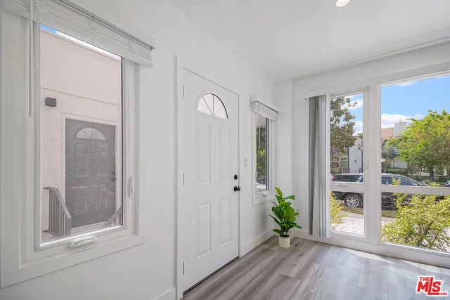 a view of an entryway with wooden floor