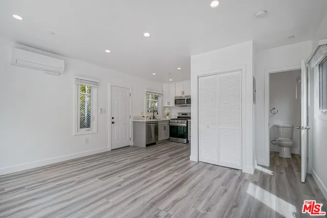 a view of a kitchen with a sink a refrigerator and window