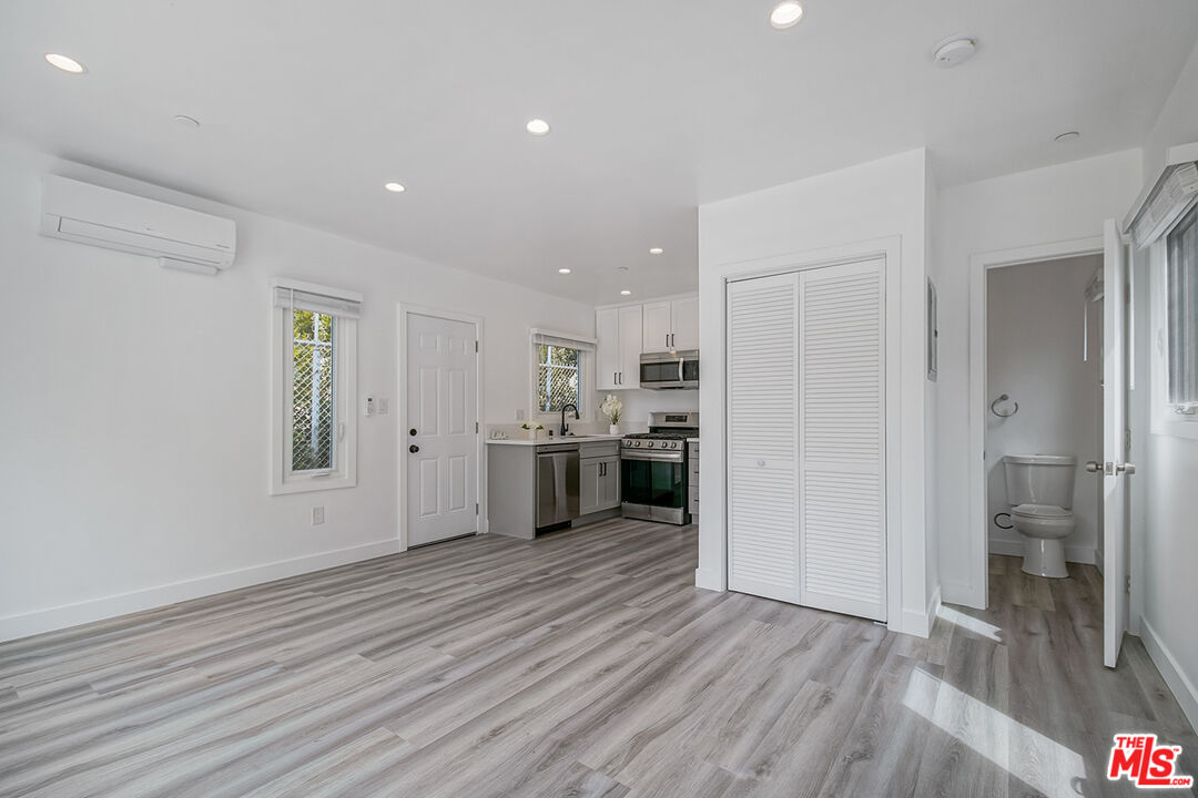 1217 9th Street, Unit 1 Santa Monica, CA 90401 - Photo 8 of 21 a view of a kitchen with a sink a refrigerator and window