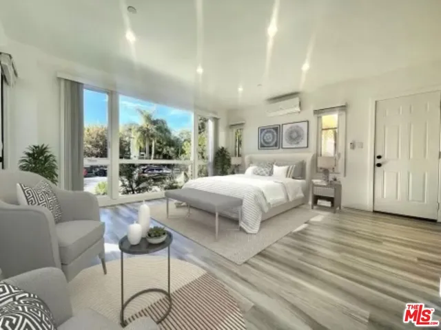 a spacious bedroom with a bed and large windows