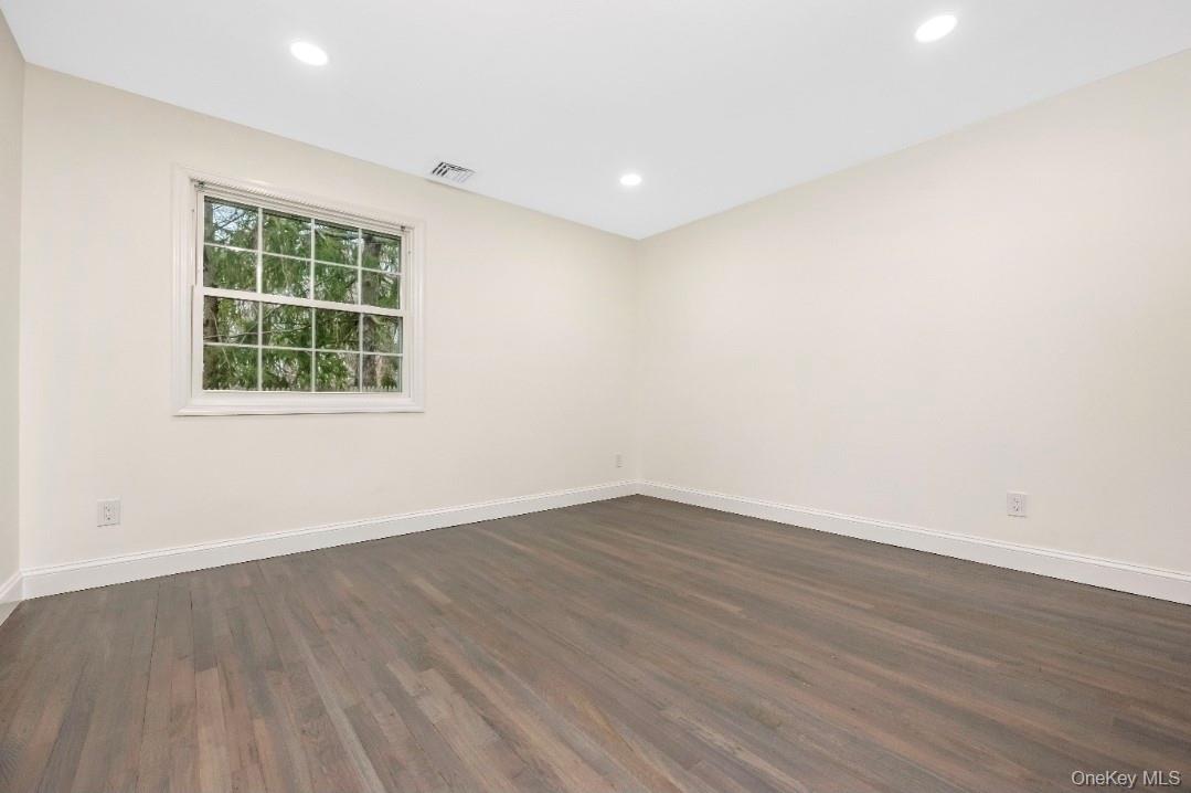 59 Nelson Road Selden, NY 11784 - Photo 20 of 38 Unfurnished room with dark wood finished floors and recessed lighting