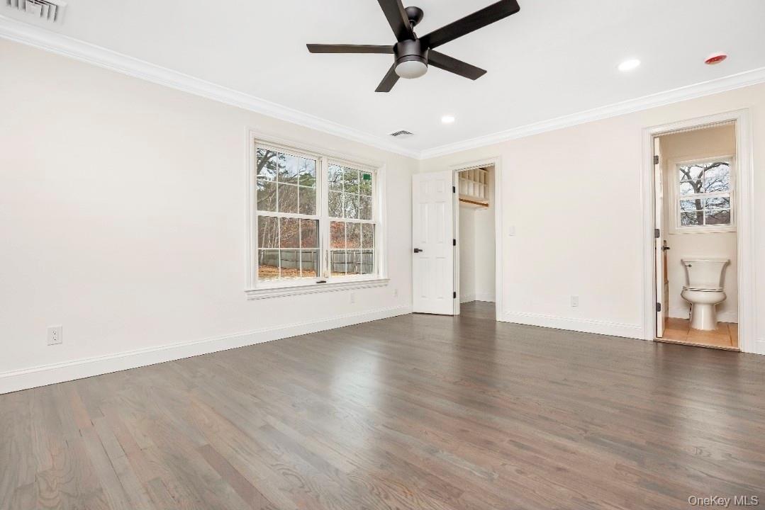 59 Nelson Road Selden, NY 11784 - Photo 27 of 38 Unfurnished bedroom with dark wood-style flooring, ornamental molding, a ceiling fan, and connected bathroom