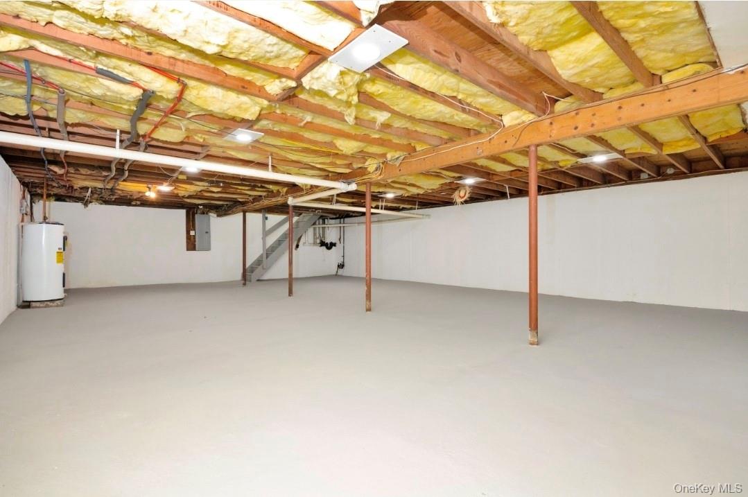 59 Nelson Road Selden, NY 11784 - Photo 30 of 38 Unfinished below grade area featuring water heater, stairway, and electric panel