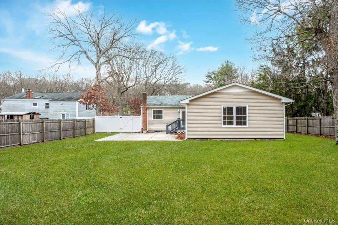 59 Nelson Road Selden, NY 11784 - Photo 5 of 38 Back of property with a patio, a fenced backyard, and a gate