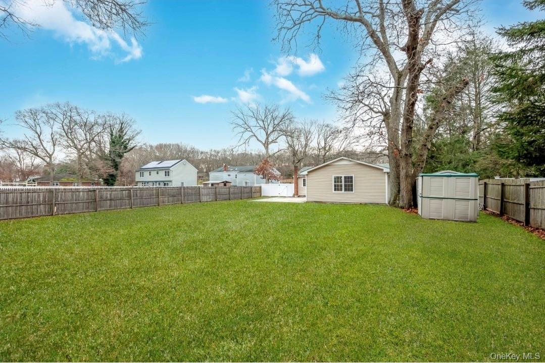 59 Nelson Road Selden, NY 11784 - Photo 6 of 38 Fenced backyard with a shed