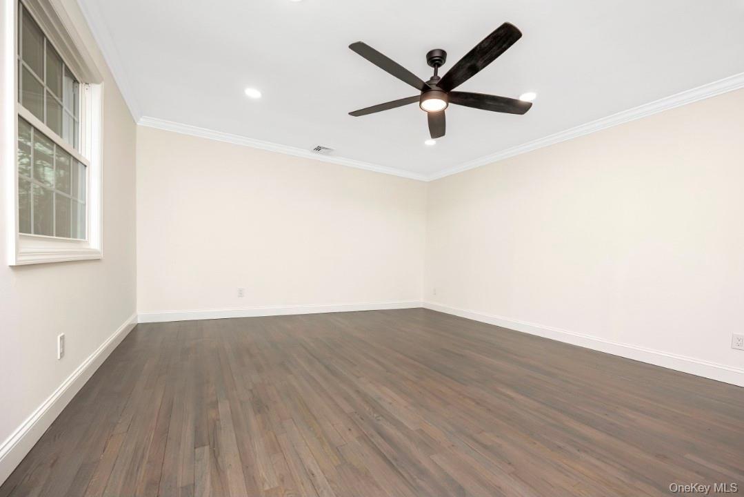59 Nelson Road Selden, NY 11784 - Photo 10 of 38 Empty room featuring dark wood-style floors, ornamental molding, recessed lighting, and a ceiling fan