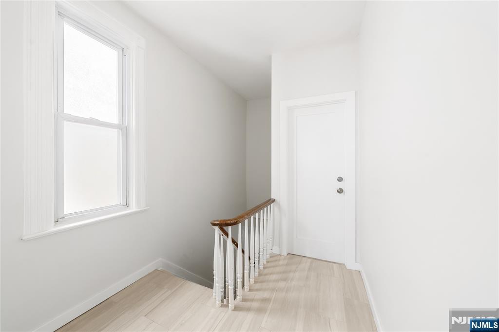 600 67th Street West New York, NJ 07093 - Photo 3 of 12 a view of a hallway with wooden floor and a window