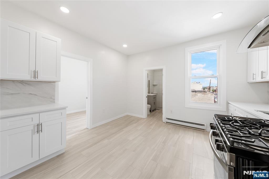 600 67th Street West New York, NJ 07093 - Photo 4 of 12 a view of an empty room with wooden floor and a window
