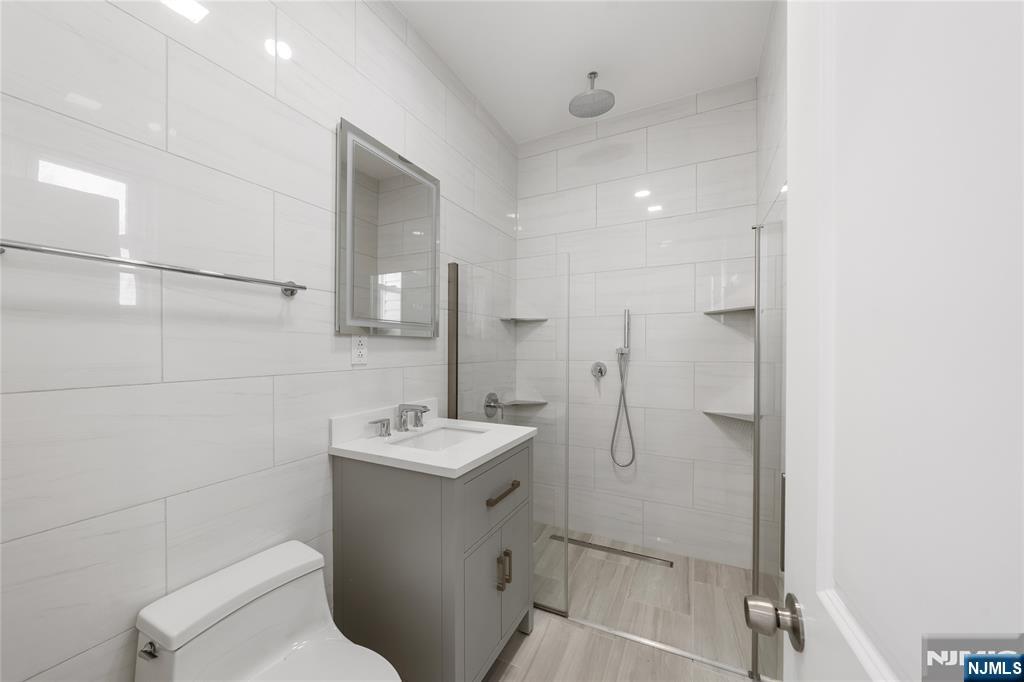 600 67th Street West New York, NJ 07093 - Photo 6 of 12 a bathroom with a toilet sink and mirror