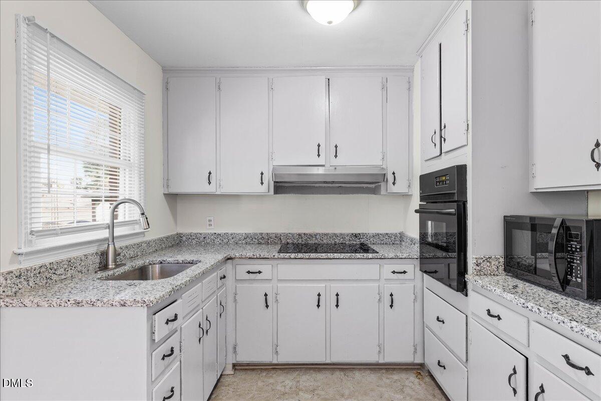 513 Calloway Drive Raleigh, NC 27610 - Photo 11 of 19 a kitchen with stainless steel appliances granite countertop a sink stove and cabinets