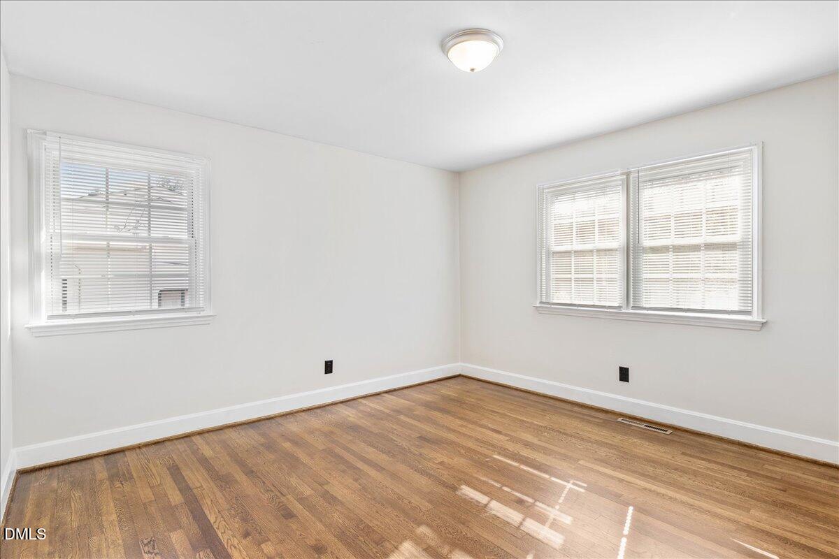 513 Calloway Drive Raleigh, NC 27610 - Photo 14 of 19 a view of empty room with wooden floor