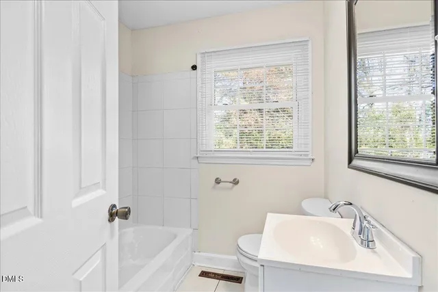 a white bath tub sitting next to a white sink