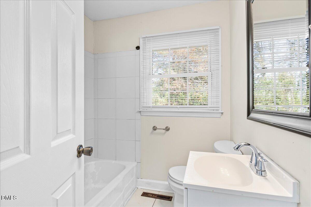 513 Calloway Drive Raleigh, NC 27610 - Photo 18 of 19 a white bath tub sitting next to a white sink