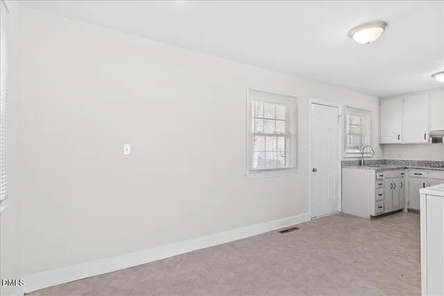 an empty room with a kitchen