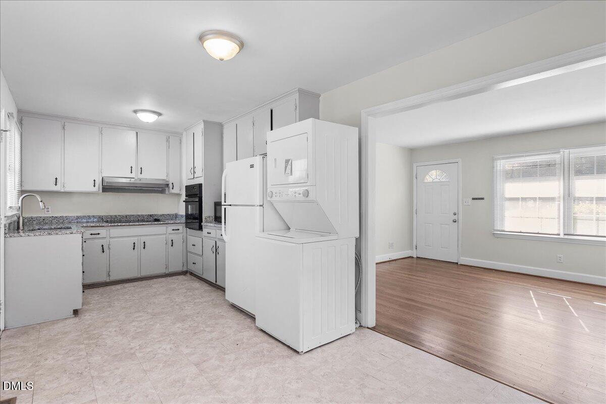 513 Calloway Drive Raleigh, NC 27610 - Photo 7 of 19 a kitchen with white cabinets and white appliances