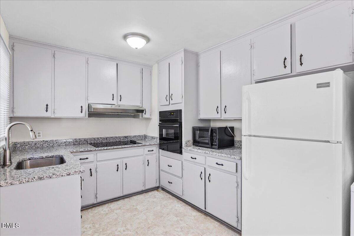 513 Calloway Drive Raleigh, NC 27610 - Photo 9 of 19 a kitchen with stainless steel appliances a refrigerator sink and cabinets