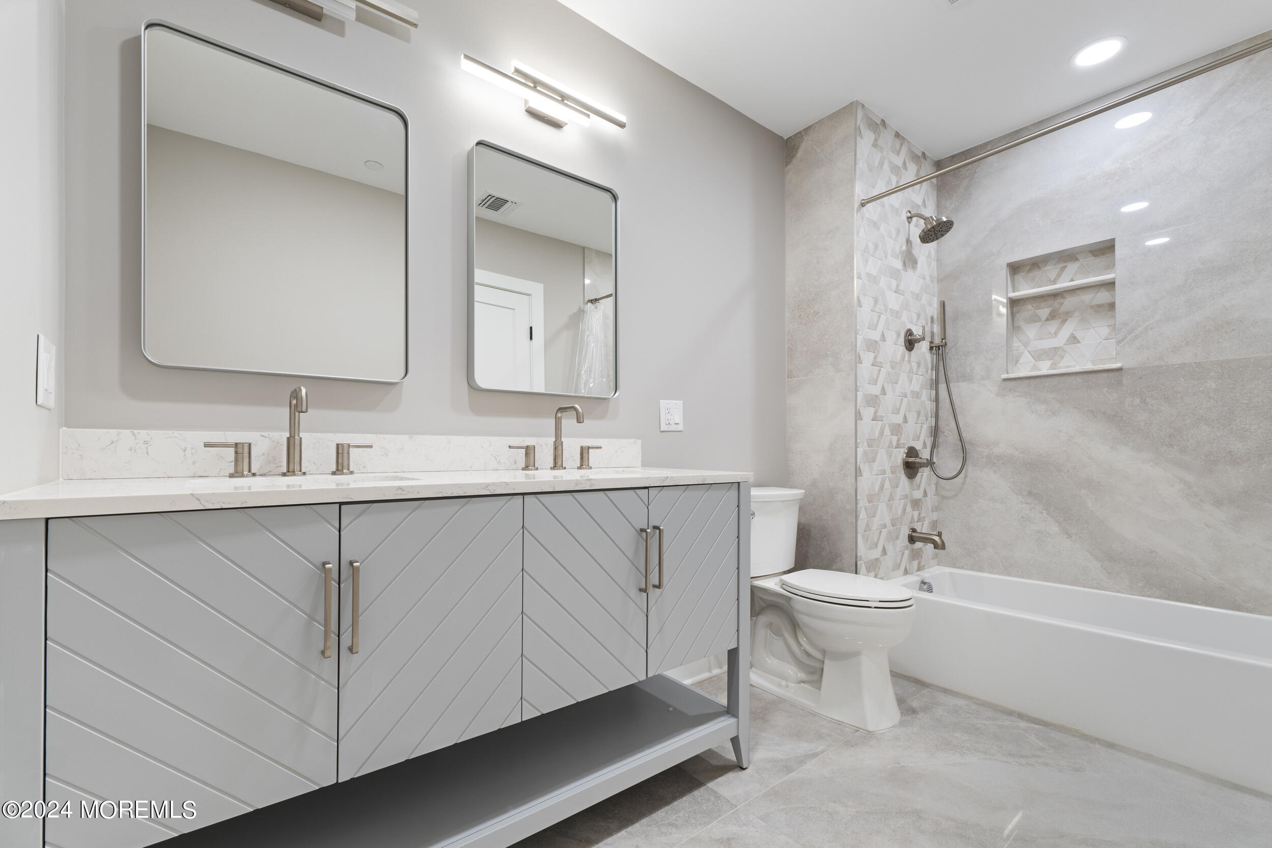 40 Seaview Avenue, Unit B Long Branch, NJ 07740 - Photo 15 of 81 a bathroom with a double vanity sink toilet mirror and bathtub