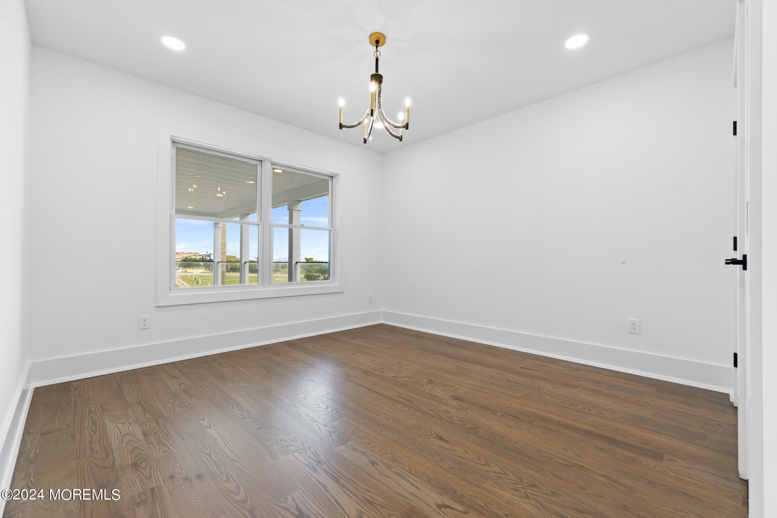 40 Seaview Avenue, Unit B Long Branch, NJ 07740 - Photo 42 of 81 an empty room with wooden floor and windows