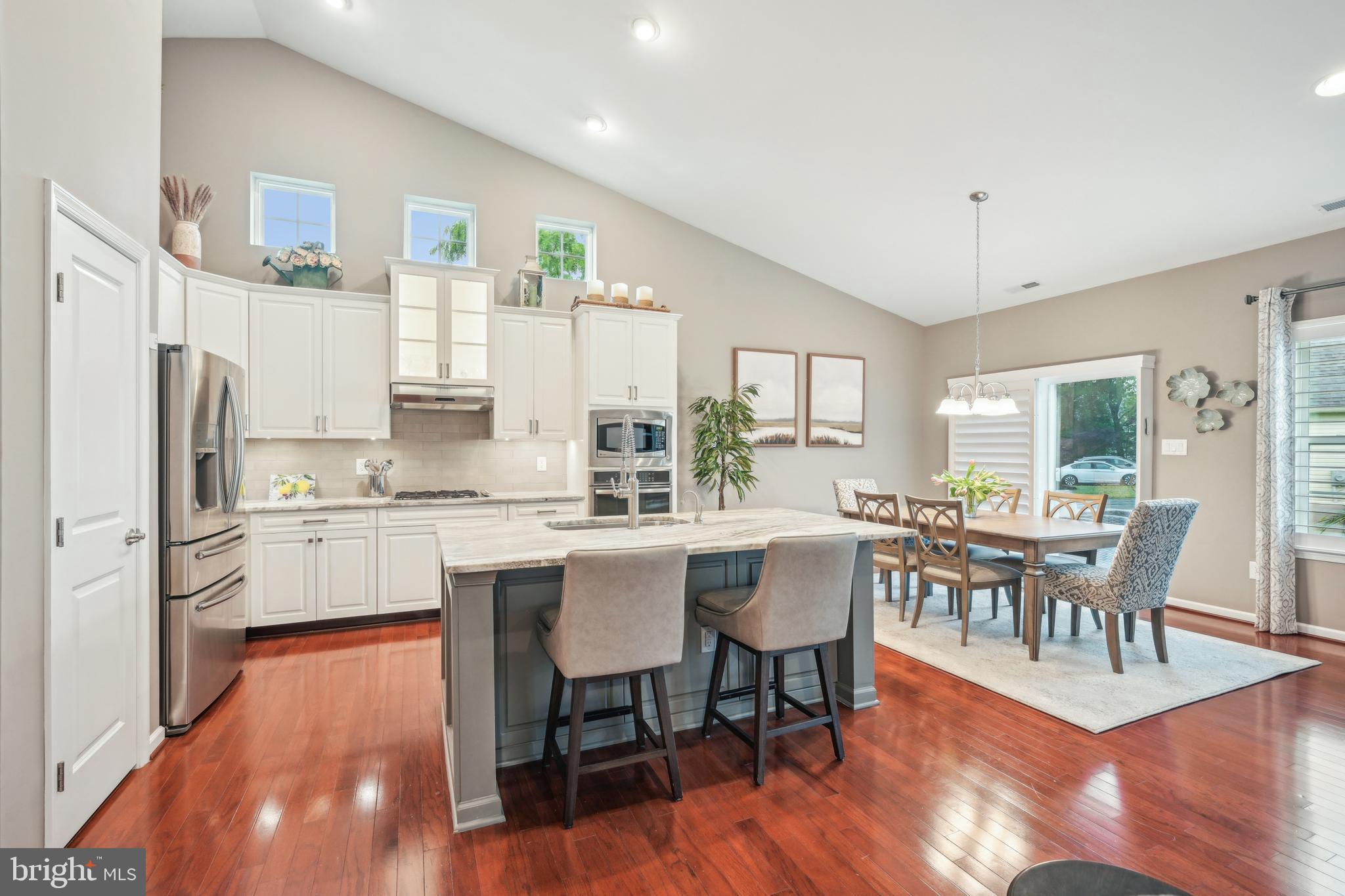 17 Alcott Way Marlton, NJ 08053 - Photo 14 of 43 a kitchen with a dining table chairs refrigerator and cabinets