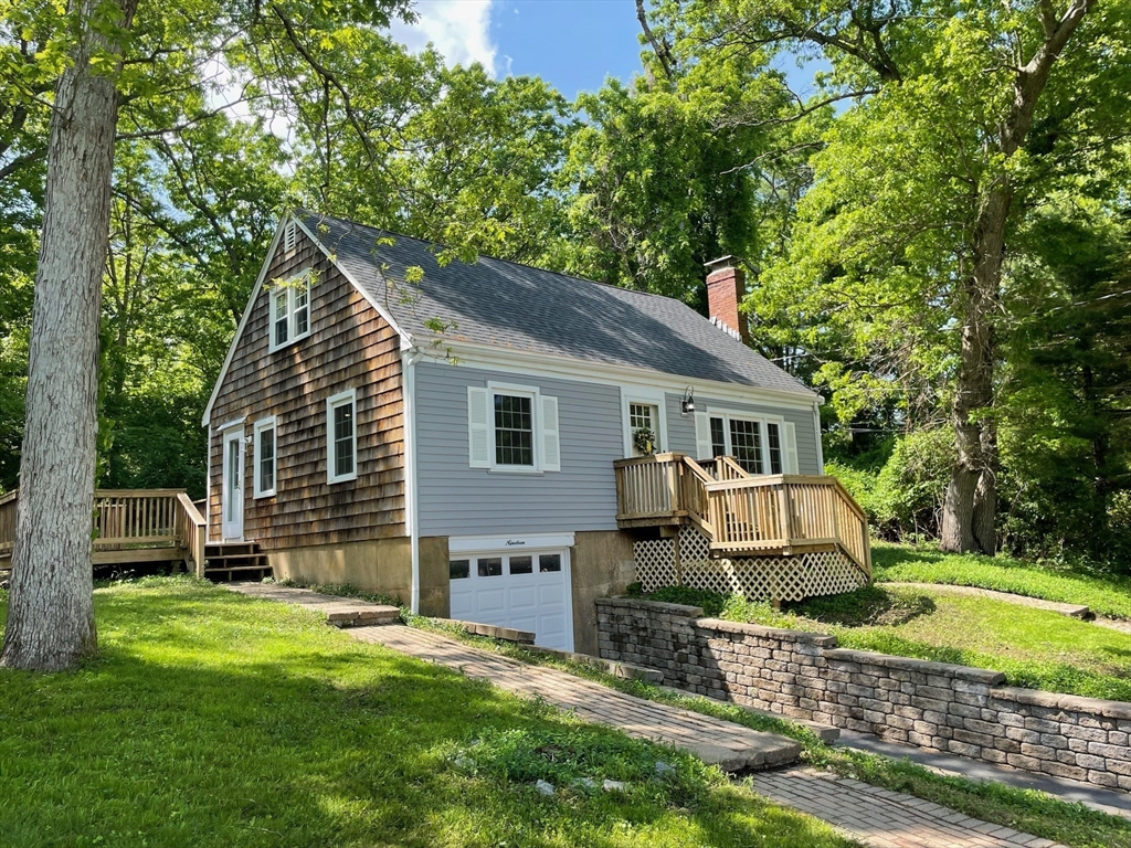 a front view of a house with a yard table and chairs