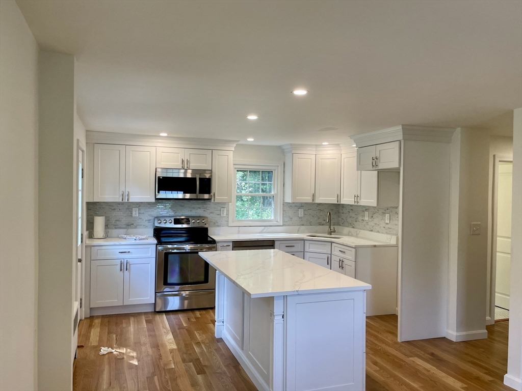 19 Robinwood Drive Canton, MA 02021 - Photo 2 of 12 a kitchen with a sink stove and refrigerator