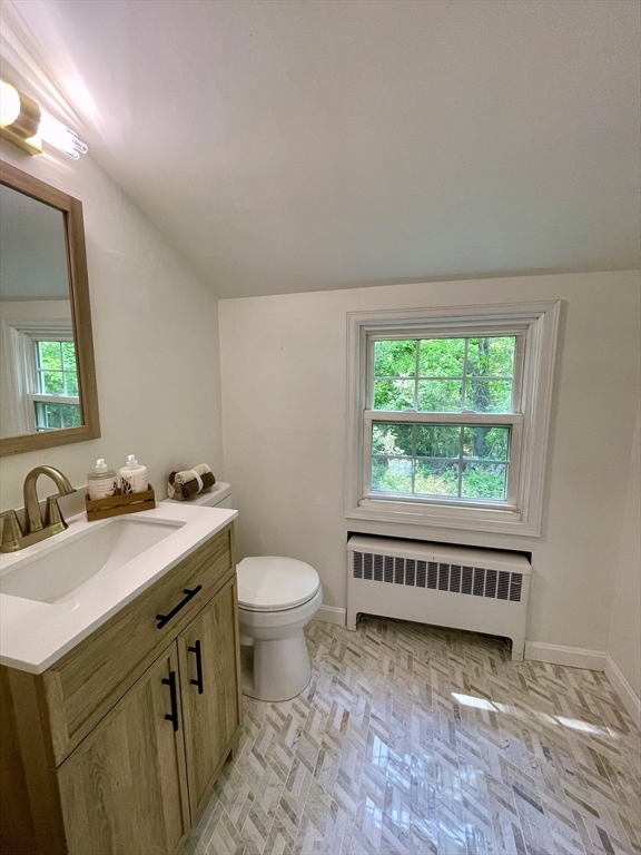 19 Robinwood Drive Canton, MA 02021 - Photo 6 of 12 a bathroom with a toilet a sink a mirror and a window