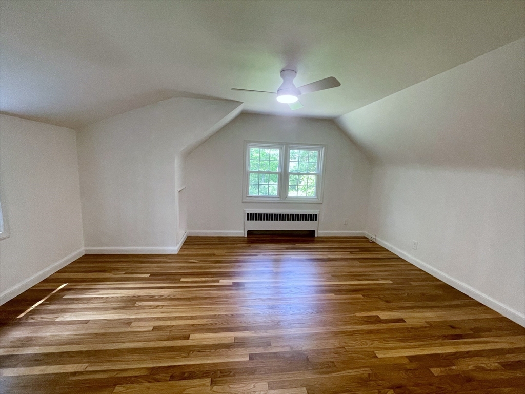 19 Robinwood Drive Canton, MA 02021 - Photo 8 of 12 a view of empty room with wooden floor and fan
