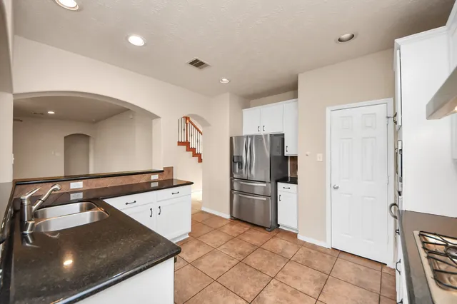 a kitchen with a refrigerator and a sink
