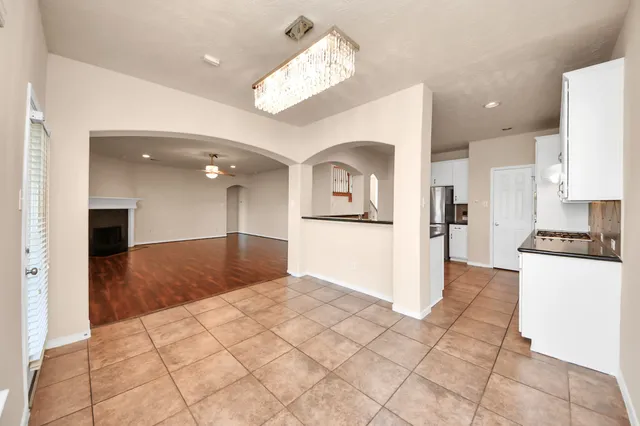 a view interior of a kitchen with stainless steel appliances kitchen island granite countertop a refrigerator and a sink