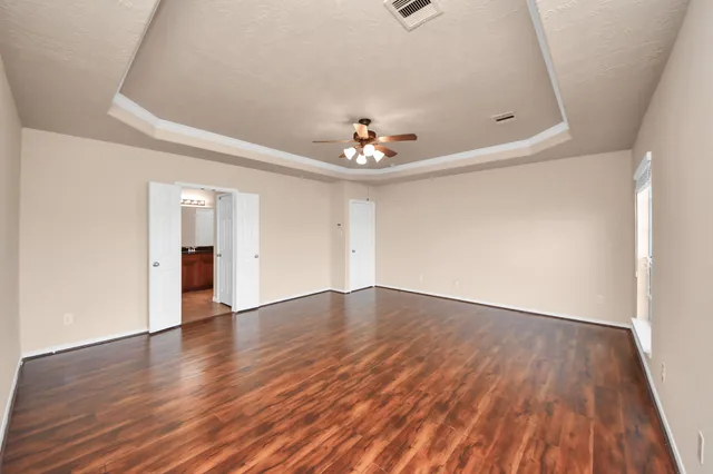 wooden floor in an empty room with a window