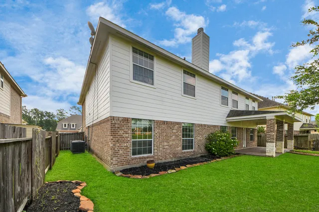 a view of a house with a yard and a garden