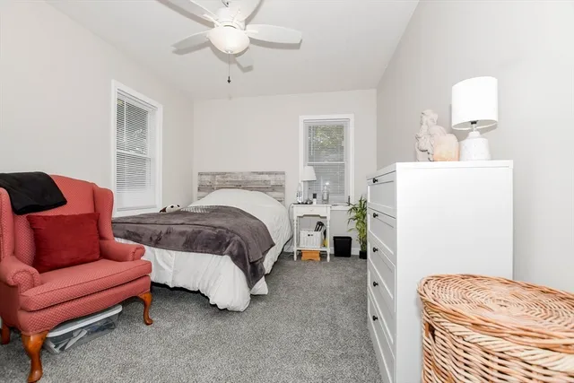 a bedroom with a bed and ceiling fan