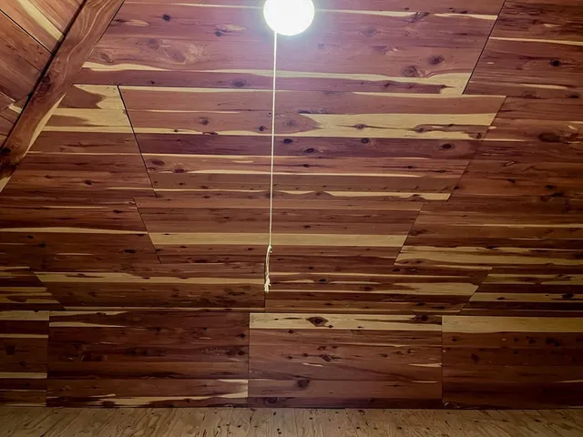 a view of a room with wooden floor and windows