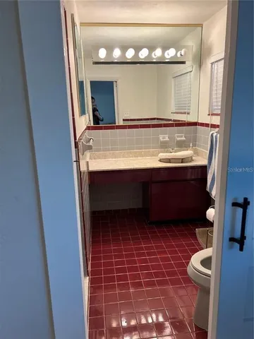 a view of bathroom with a sink and a mirror