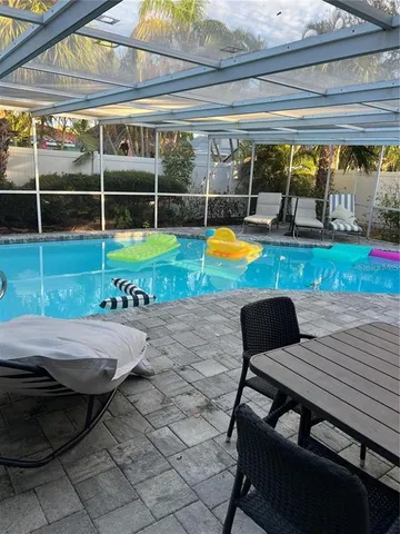 a view of swimming pool with sitting area