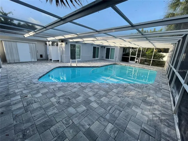 a view of a backyard with large trees and a small yard