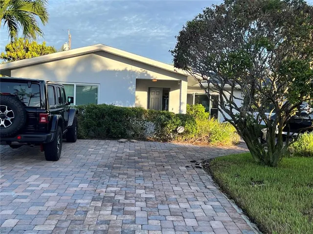 a backyard of a house with yard and outdoor seating