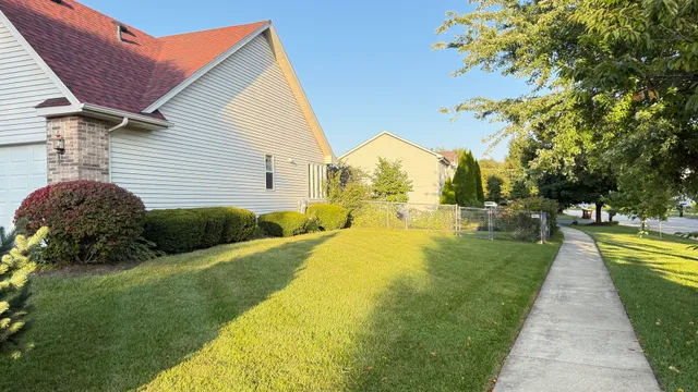 a view of a house with a backyard