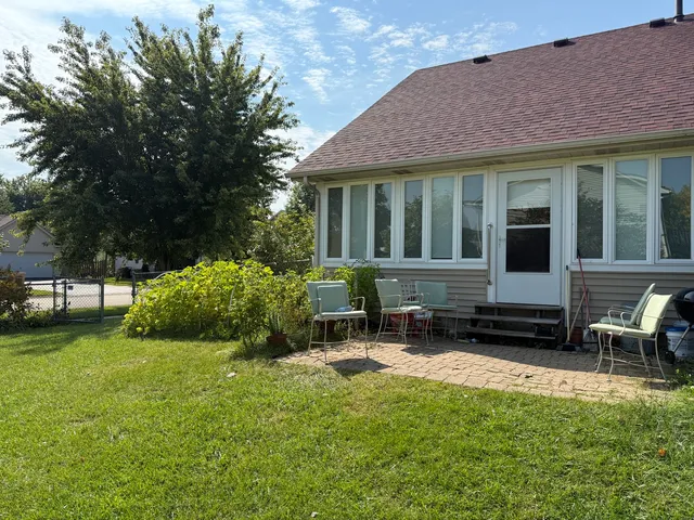 a front view of a house with yard and green space