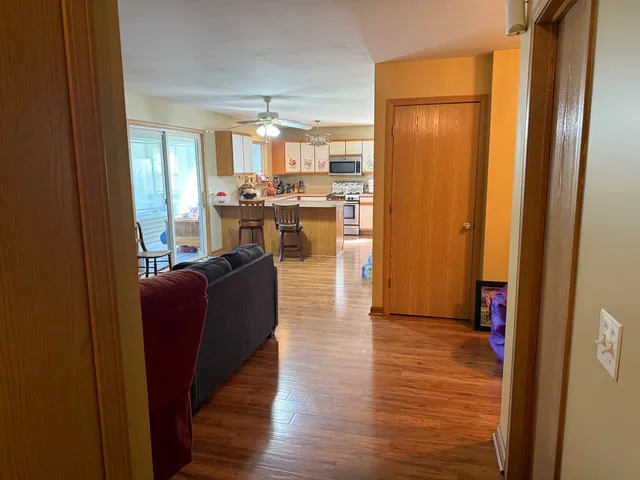 a living room with furniture and a wooden floor
