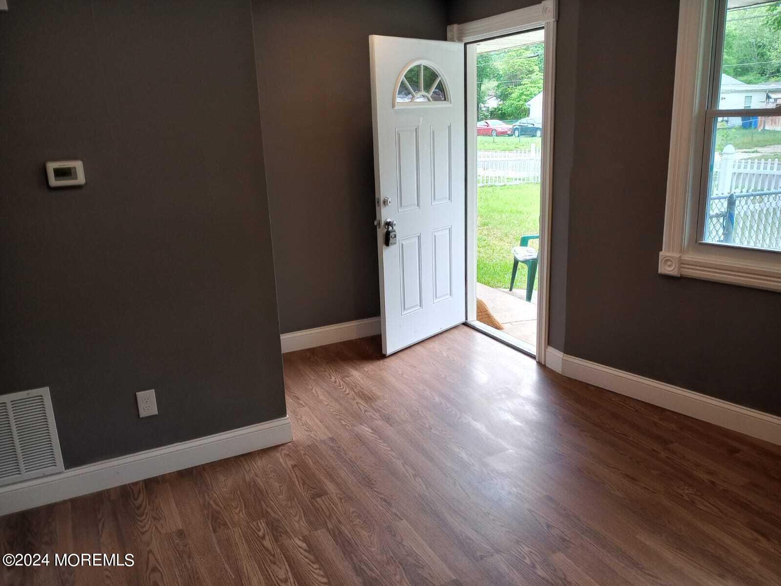 179 Kinsley Road Pemberton, NJ 08068 - Photo 1 of 9 an empty room with wooden floor and windows