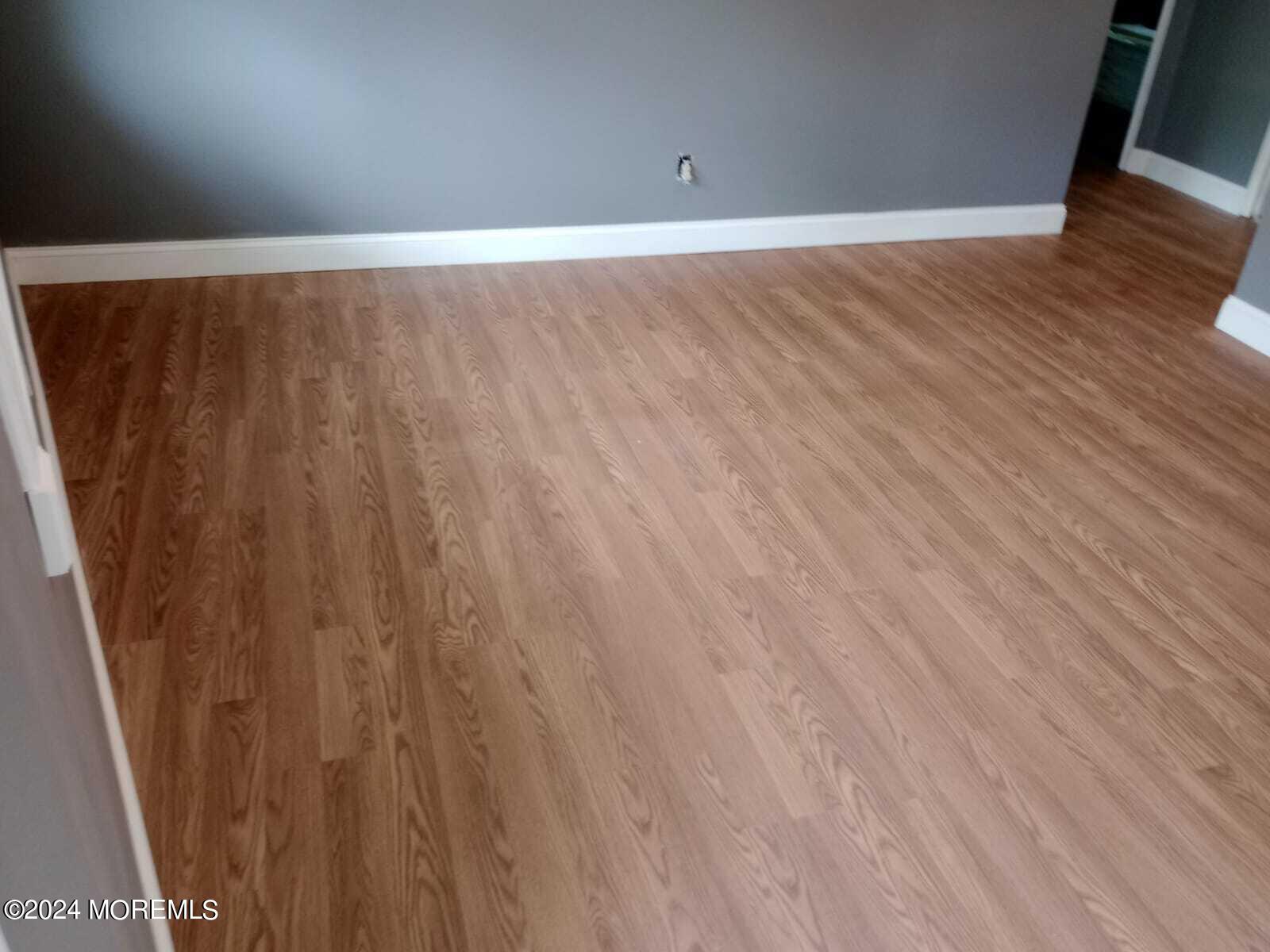 179 Kinsley Road Pemberton, NJ 08068 - Photo 5 of 9 a view of an empty room with wooden floor