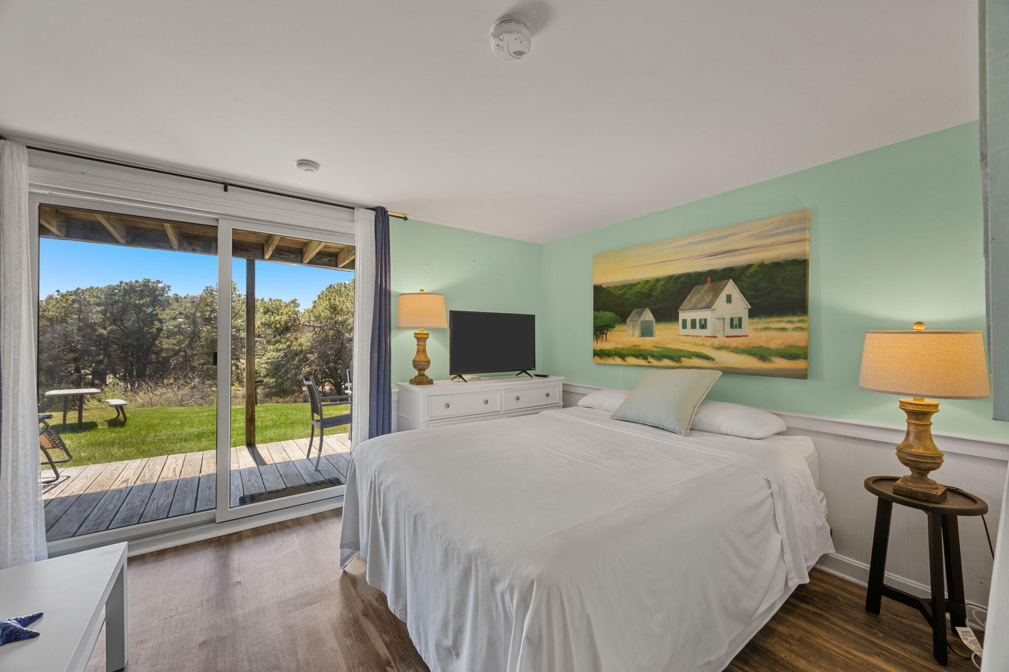 132 Shore Road, Unit 13 Truro, MA 02666 - Photo 10 of 21 a bedroom with a large bed and a large window