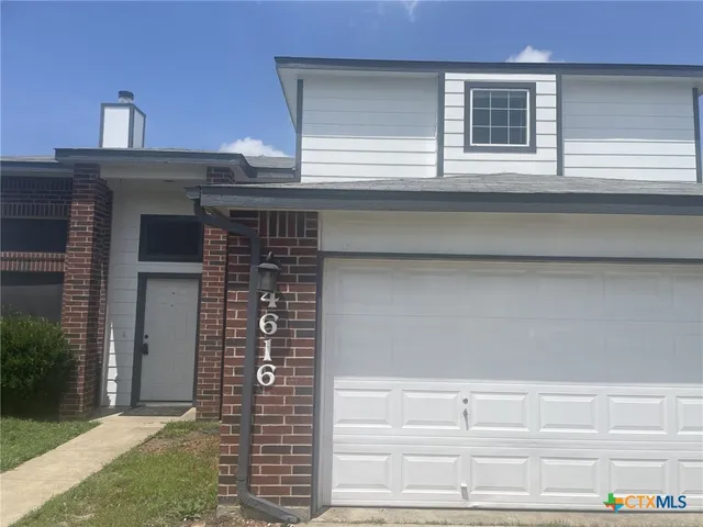 a front view of a house with garage