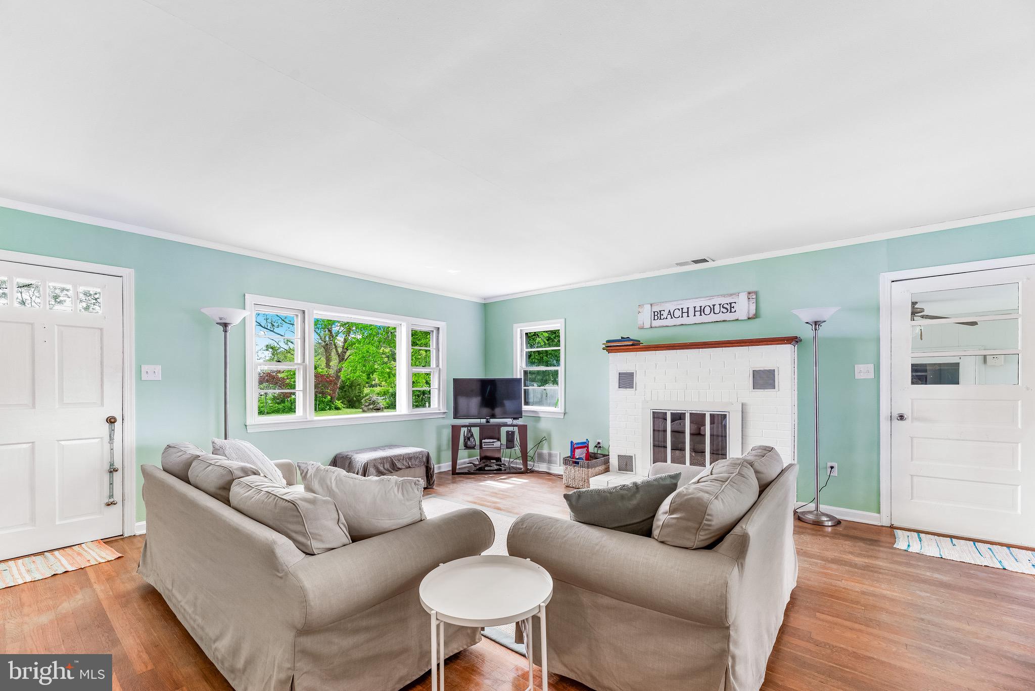 16410 Fishermen Way Ridge, MD 20680 - Photo 4 of 34 a living room with furniture and a large window