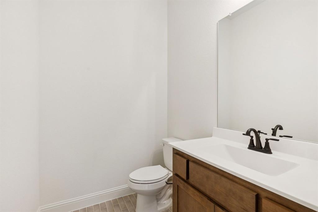 7016 Valley View Drive Joshua, TX 76058 - Photo 24 of 28 a bathroom with a sink a toilet and mirror