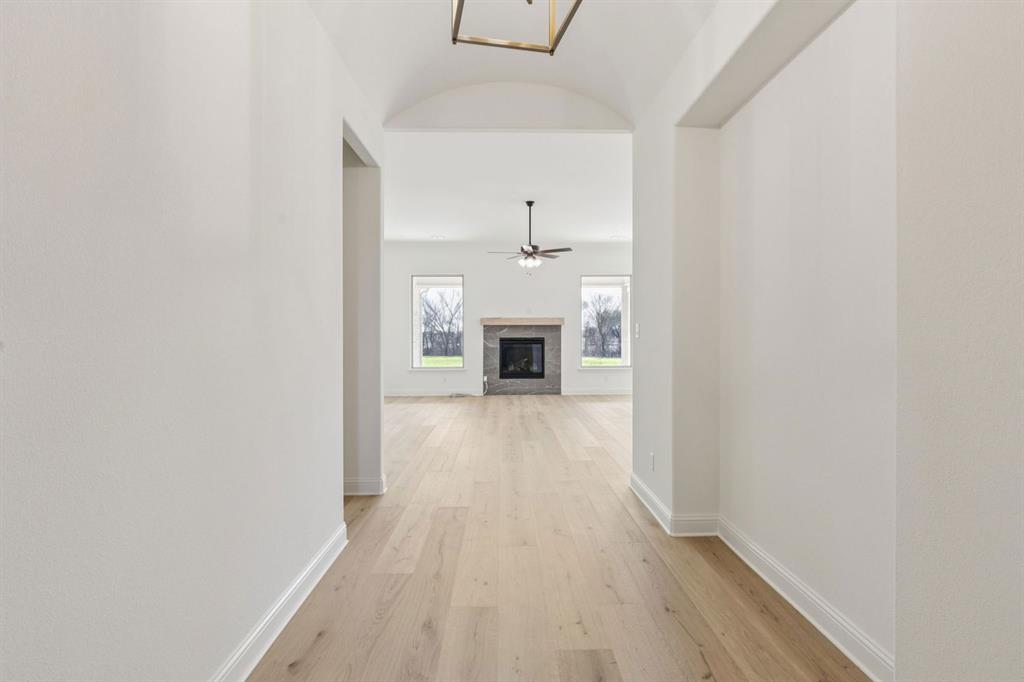7016 Valley View Drive Joshua, TX 76058 - Photo 4 of 28 a view of a hallway with wooden floor and a fireplace