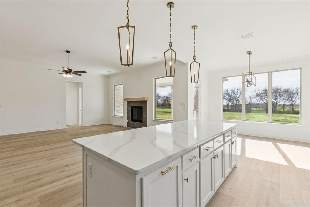 7016 Valley View Drive Joshua, TX 76058 - Photo 6 of 28 a view of open kitchen with a sink and refrigerator
