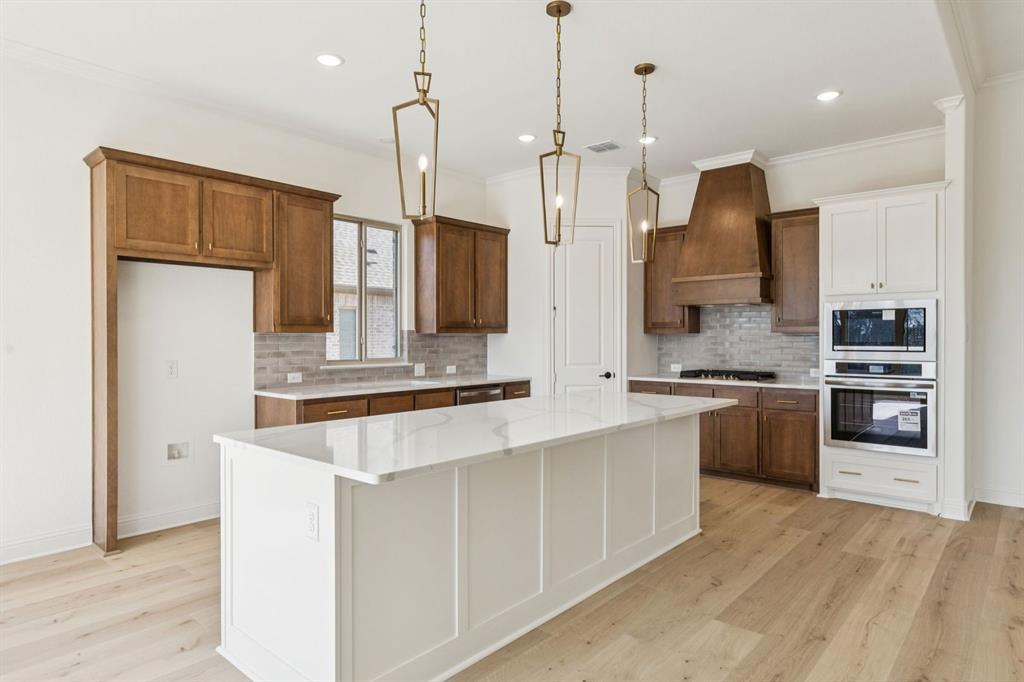 7016 Valley View Drive Joshua, TX 76058 - Photo 8 of 28 a kitchen with stainless steel appliances kitchen island granite countertop a refrigerator a oven a sink a stove and a wooden floors