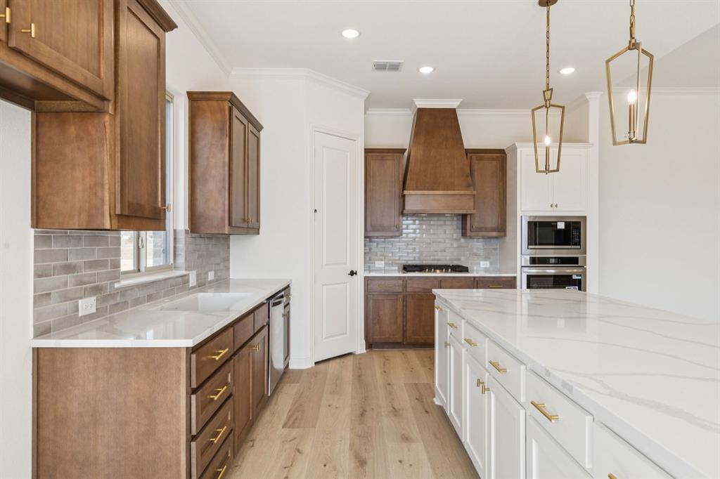 7016 Valley View Drive Joshua, TX 76058 - Photo 9 of 28 a kitchen with stainless steel appliances granite countertop a sink stove and refrigerator